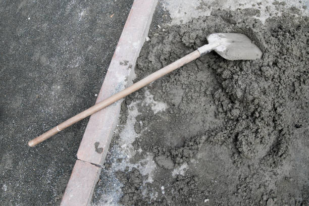 shovel in concrete when laying paving slabs