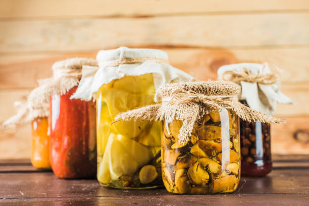 istock Preserved vegetables on wooden background 1154050699