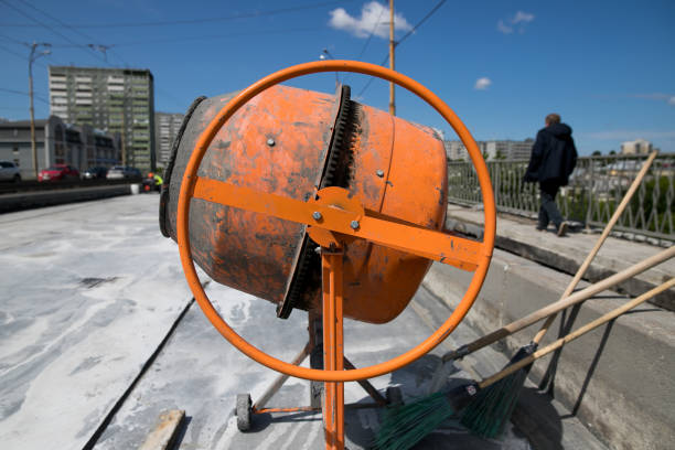 istock orange concrete mixer prepares cement mortar 1154051484