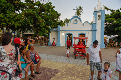 Praia do Forte, Brazil - 31 January 2019: people visiting the colonial church of mainly square in the Praia do Forte on Brazil