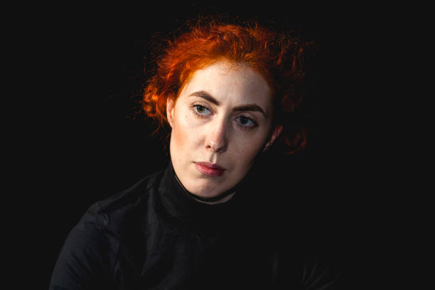 istock red-haired young woman portrait in studio 1154054470