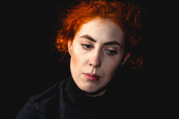 istock red-haired young woman portrait in studio 1154054490