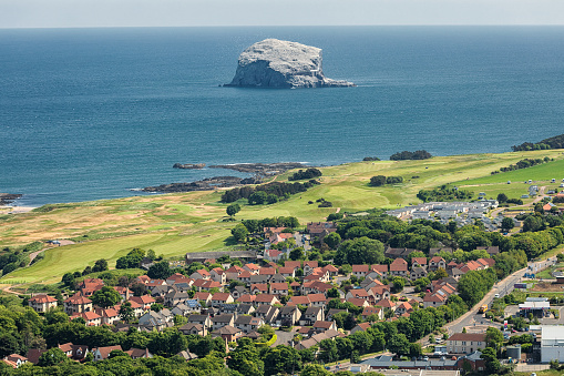 View on Bass Rock island and North Berwick city from above North Berwick Law,  East Lothian, Scotland. North Sea. Bass Rock island is place where live colony of northern gannets.