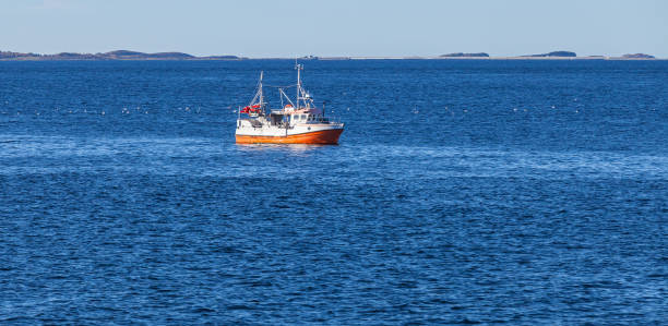 istock Small orange white fishing boat 1154059467