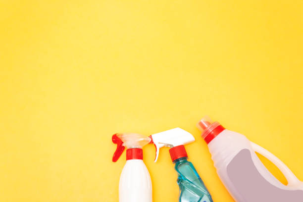 istock cleaning product on yellow background side view. Professional cleaning products, spring cleaning. Household chemicals 1154059569