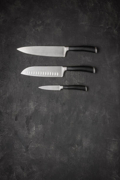 istock Set of Kitchen Knives on Stone Background 1154060525
