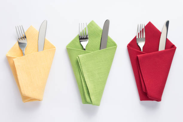 istock knife and fork in folded napkin at white background 1154060753