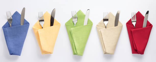 istock knife and fork in folded napkin at white background 1154060774