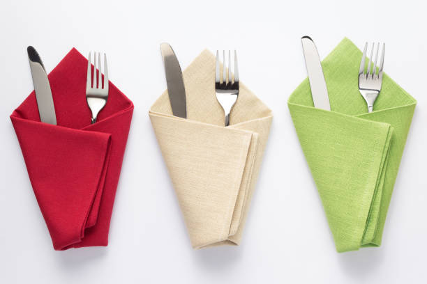 istock knife and fork in folded napkin at white background 1154060812
