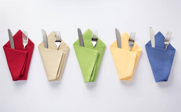 istock knife and fork in folded napkin at white background 1154060922
