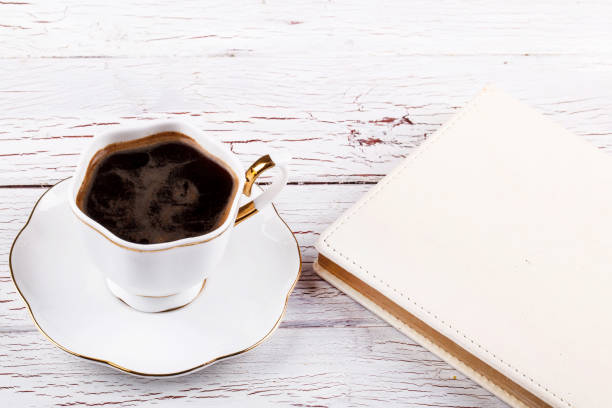 istock Porcelain cup with coffee on white table 1154061898