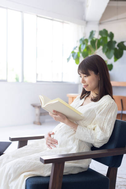 istock Pregnant woman reading a book 1154061967