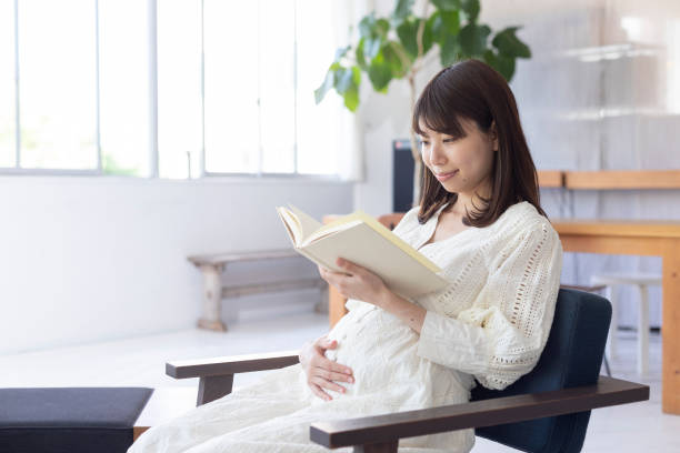 istock Pregnant woman reading a book 1154062056
