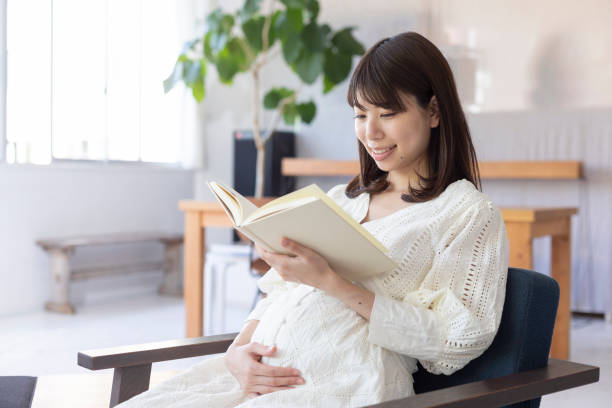 istock Pregnant woman reading a book 1154062071