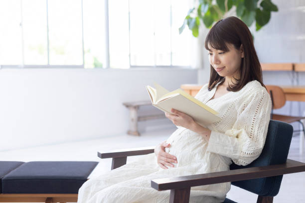 istock Pregnant woman reading a book 1154062091