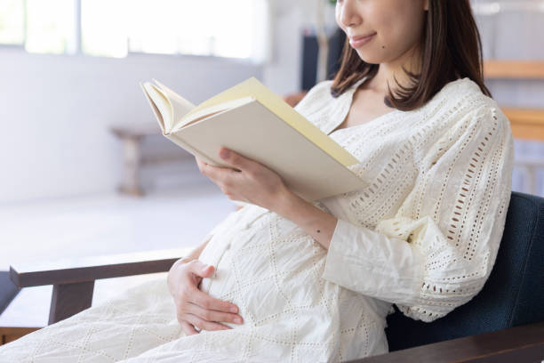 istock Pregnant woman reading a book 1154062166