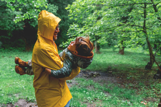 istock Having fun with my Dad on a rainy day in a park 1154063895