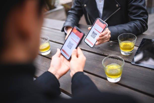 istock Young Japanese Friends Showing Smart Phone Apps 1154064351