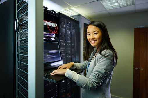 young IT professional portrait in a server room