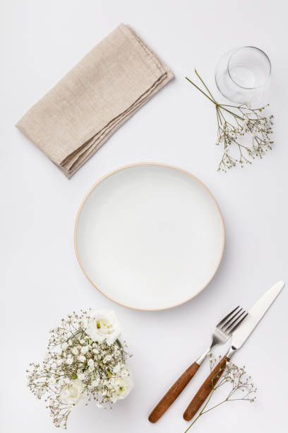 istock Empty white plate and cutlery on a napkin 1154065089