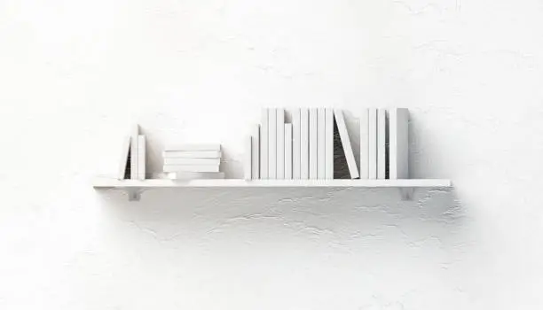 Photo of Blank white stack of books mock ups on shelf mounted