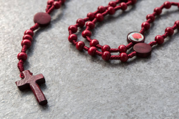 istock Closeup of a red rosary on a stone background 1154065385