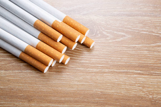 istock Several cigarettes on a wooden background 1154067360