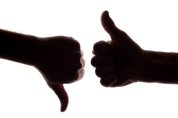 istock Young and old man show like and dislike - silhouette 1154067486