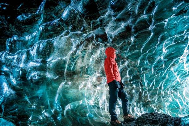 istock Hiking man stand at ice cave 1154067633