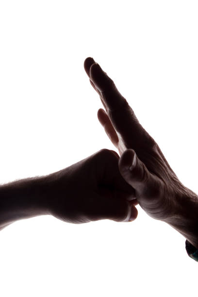 istock Male hands young and old together cooperation - silhouette 1154067683