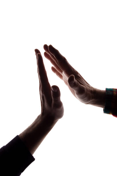 istock Male hands young and old together cooperation - silhouette 1154067862