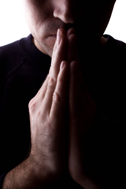 istock Man's hand together, prayer and request - silhouette 1154067940