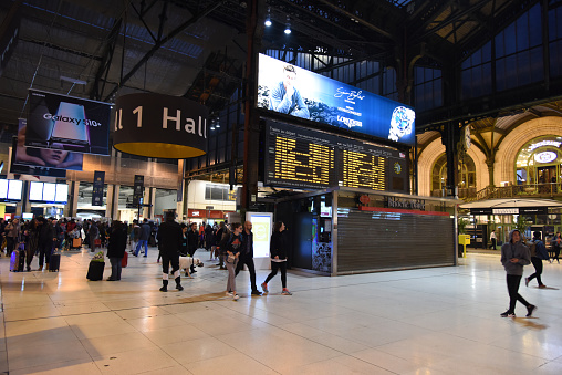 The Gare de Lyon is one of the six large mainline railway station termini in Paris, France. It handles about 90,000,000 passengers every year, making it the third busiest station of France. The Image shows the main Hall with many passengers waiting for their next connections.