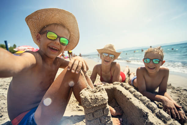 Children having fun building sandcastles on beach