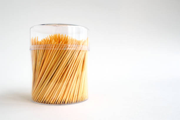 bamboo toothpicks in a plastic lidded storage box on white background, copy space