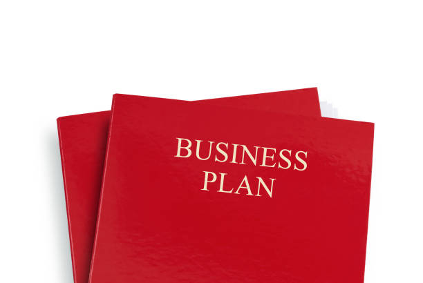 Business plan in red folder isolated on white. Shot from above