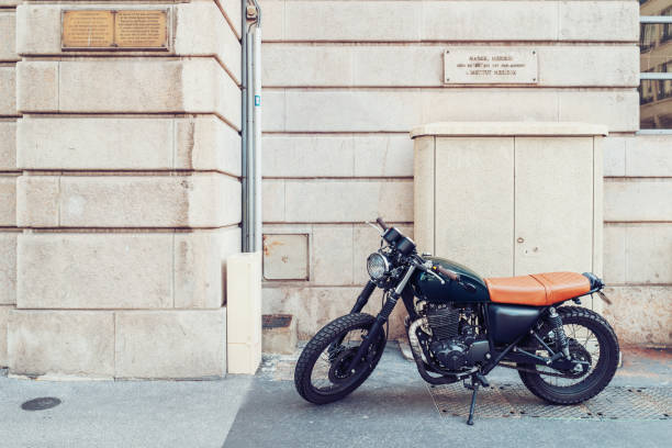 Lyon, France - May 7, 2019. A vintage motorcycle parket in the historical center of Lyon Lyon, France - May 7, 2019. A vintage motorcycle parket in the historical center of Lyon cafe racer stock pictures, royalty-free photos & images