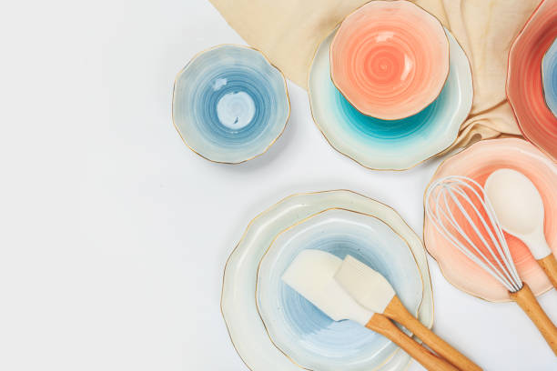istock Varicolored ceramic plates and bowls on white background 1154071652