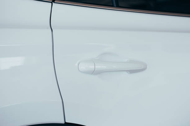 istock Closeup of white car door handle 1154071917
