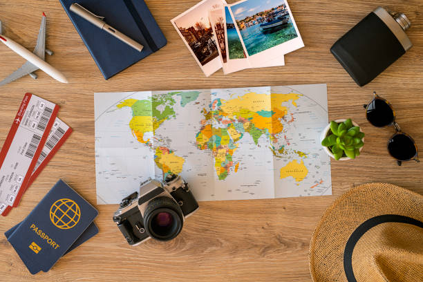 Ready for travel Travel stuff on desktop: map, sun glasses, camera, tickets, passport etc. discover card stock pictures, royalty-free photos & images