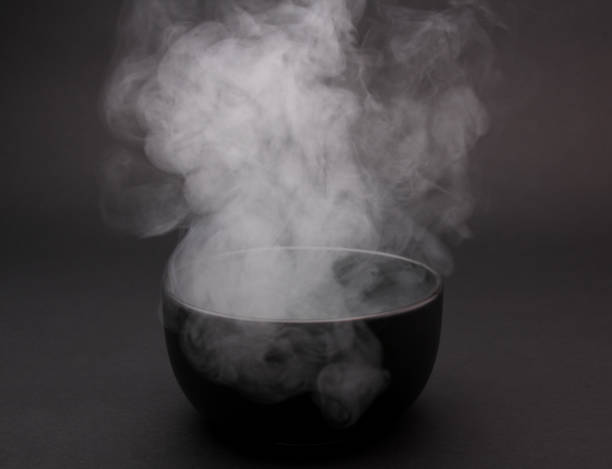 istock Bowl of hot soup on black background. 1154075803