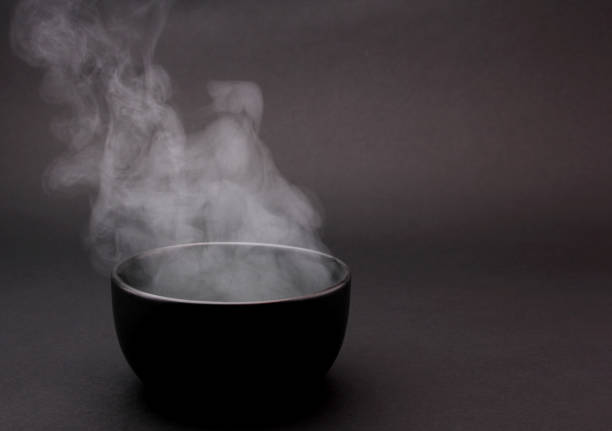 istock Bowl of hot soup on black background. 1154075807