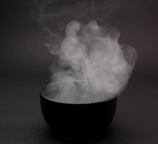 istock Bowl of hot soup on black background. 1154075835