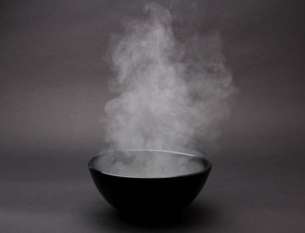istock Bowl of hot soup on black background. 1154075857