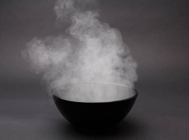 istock Bowl of hot soup on black background. 1154075862