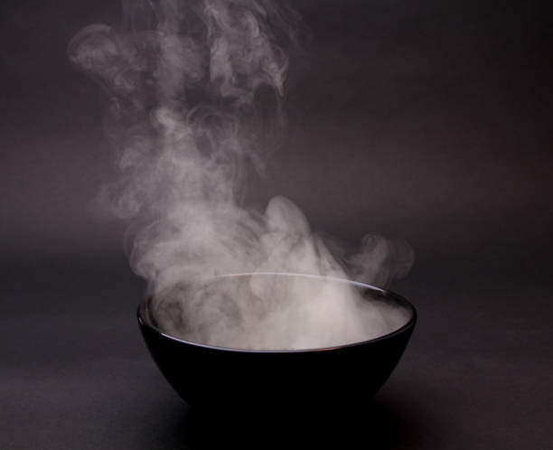 istock Bowl of hot soup on black background. 1154075864