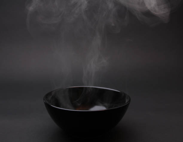 istock Bowl of hot soup on black background. 1154075879