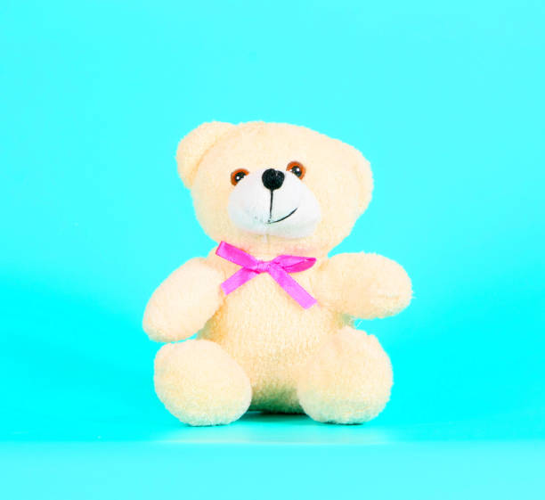 istock Cute teddy bear on a turquoise background. 1154076348