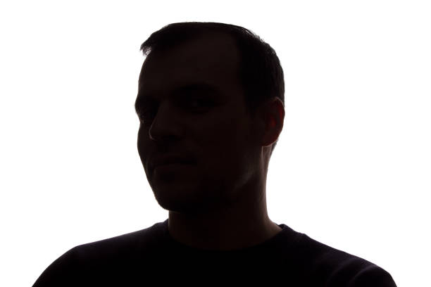istock Portrait of a young man, side view - dark isolated silhouette 1154077334