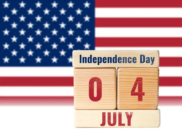 4 july independence day, wooden blocks calendar over defocused united states flag background